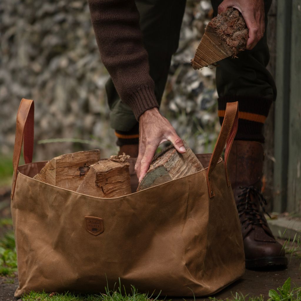 Waxed canvas log bag being filled with logs