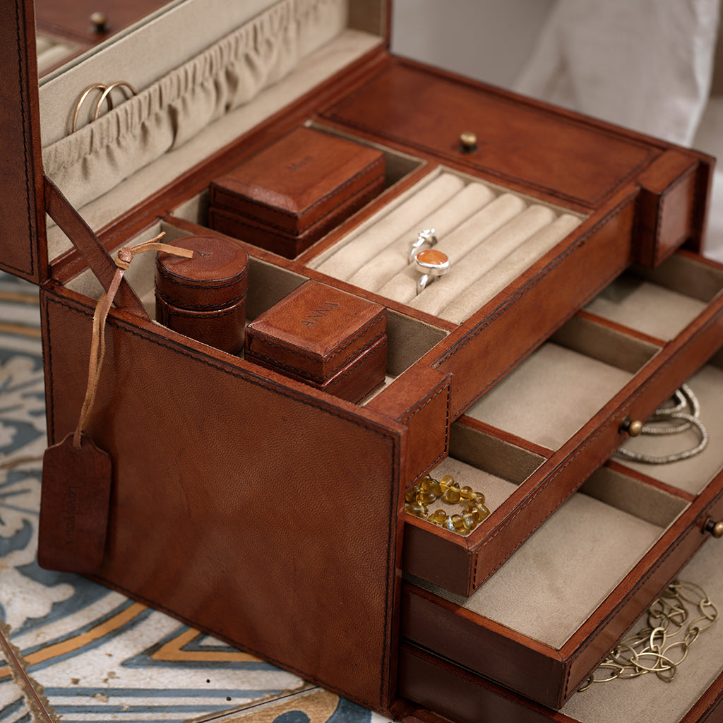 leather jewellery case with internal mirror and drawers close up of jewellery case open showing different boxes that can be personalised - including a leather personalised mini tag