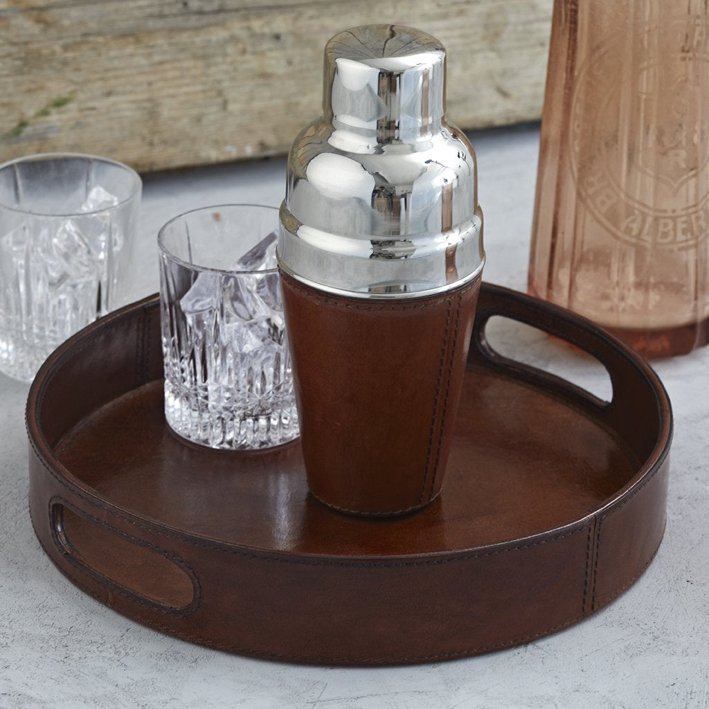Leather cocktain shaker on round leather tray