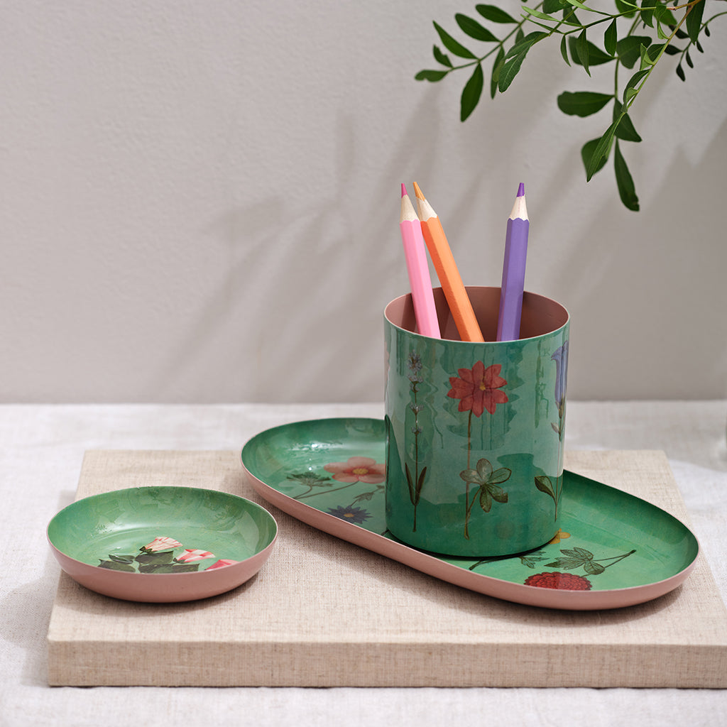 Set of ceramic items with floral design on a neutral background