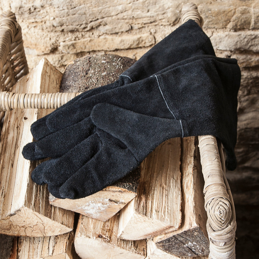 Black gloves on a textured stone surface