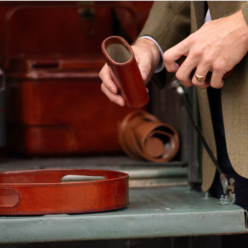 Person holding empty leather dice shaker