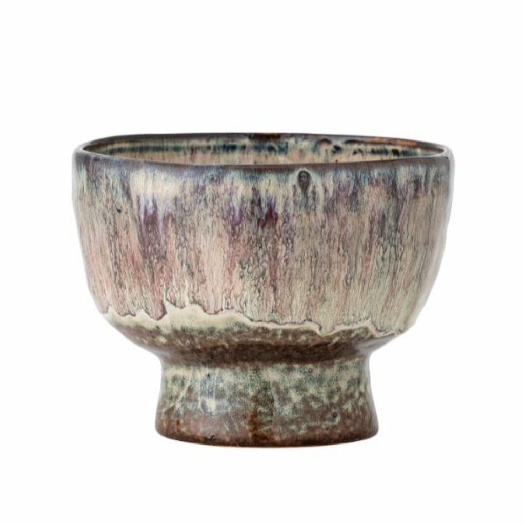Ceramic plant pot with a textured surface on a white background