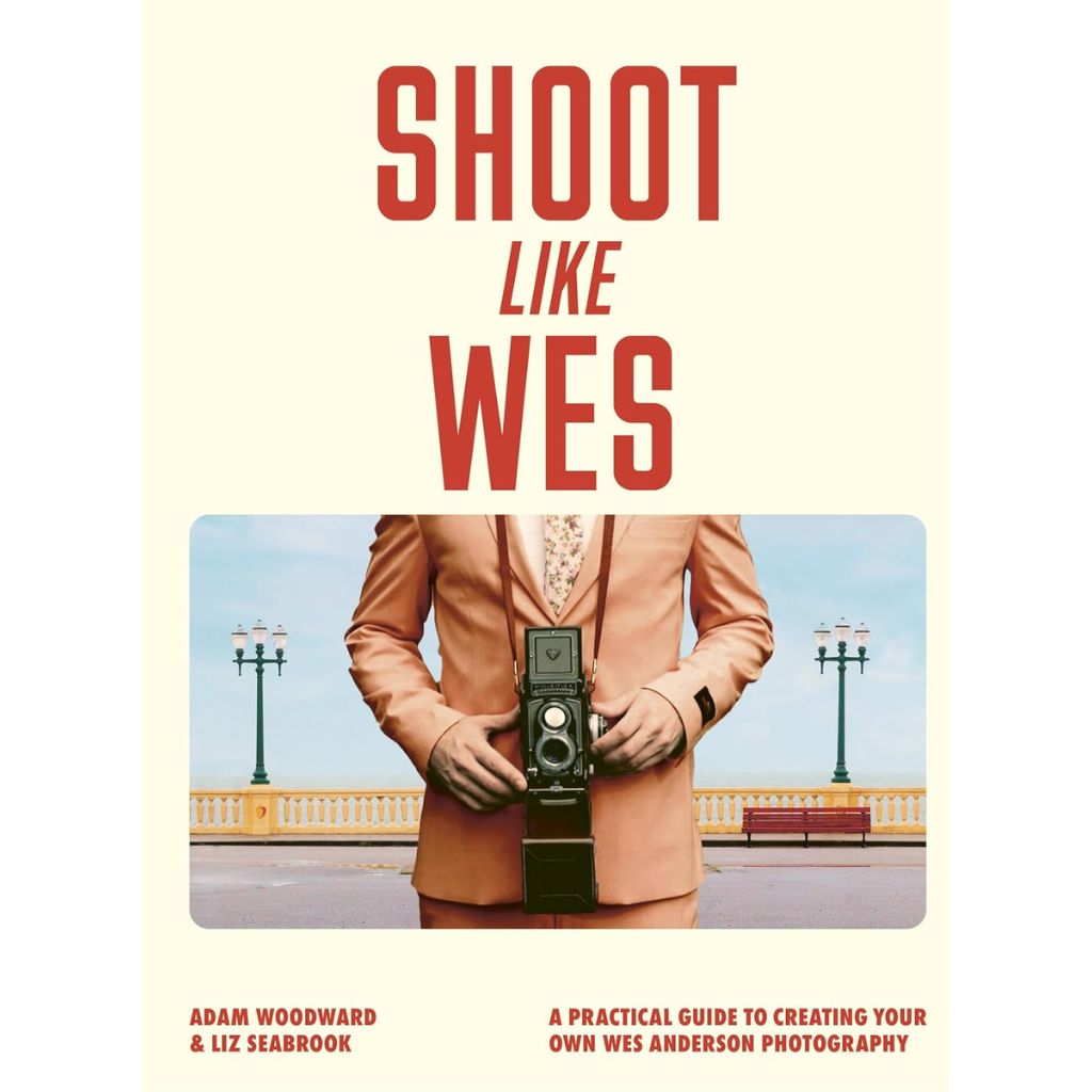 Book cover of 'Shoot Like Wes' with a person holding a camera, set against a light background.