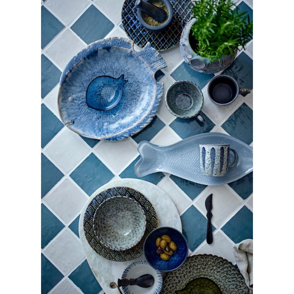 Blue ceramic tableware on a checkered blue and white tablecloth
