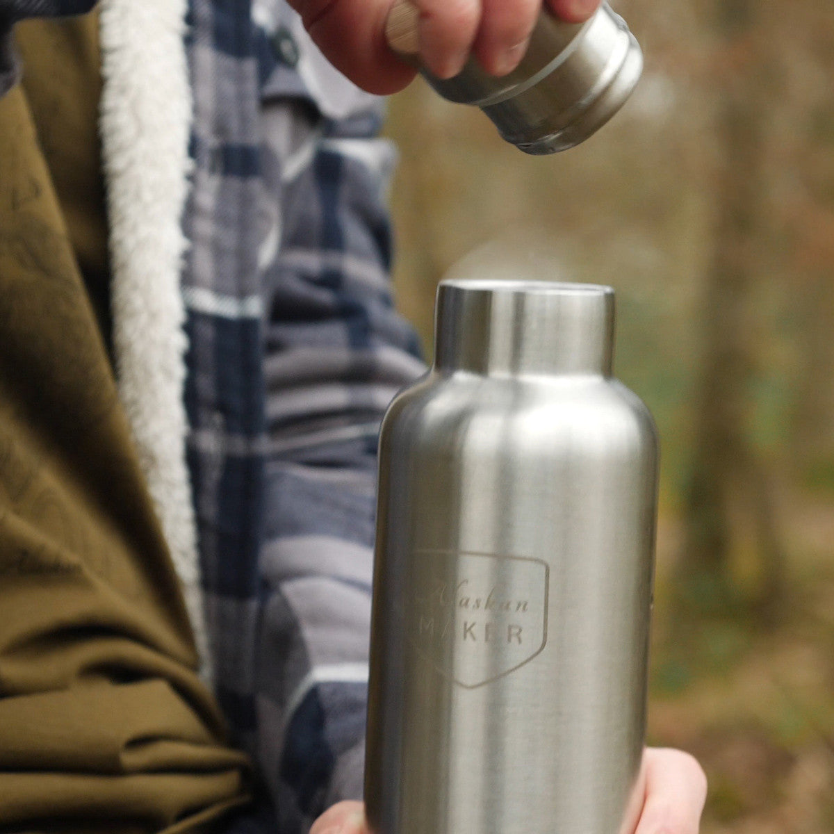 Stainless steel water bottle being used for steaming hot drinks