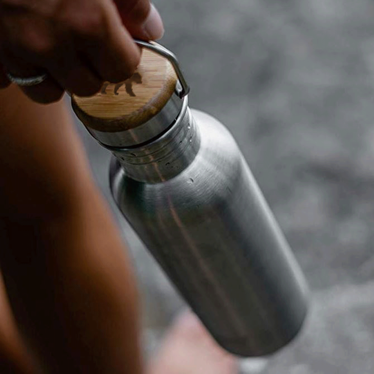 Stainless steel water bottle being held