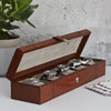 Leather watch box for five watches shown open with watches in the five compartments.