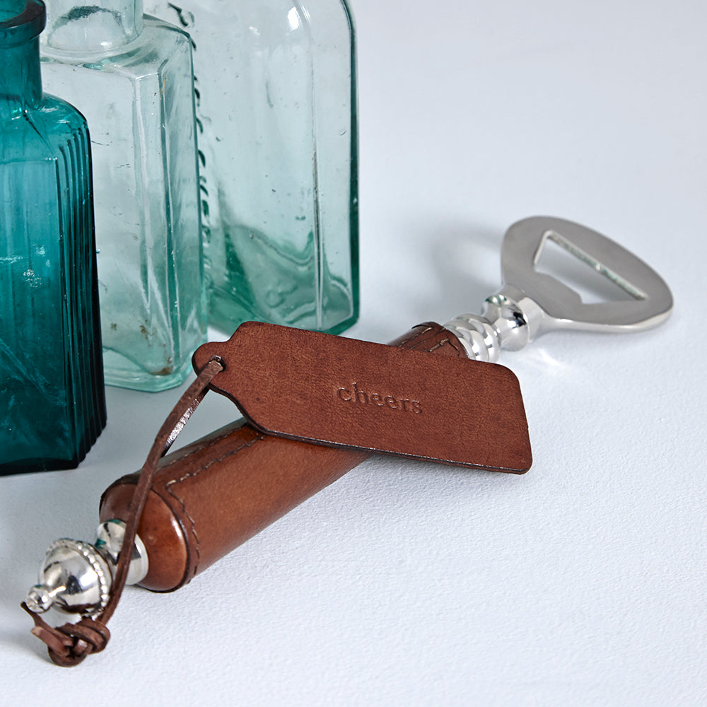 Leather handled bottle opener with a personalised mini gift tag, reading cheers, a great present