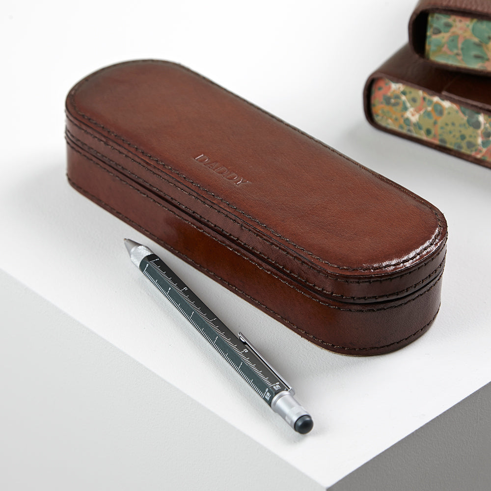 Leather pen box with the word DADDY embossed to the top of the box