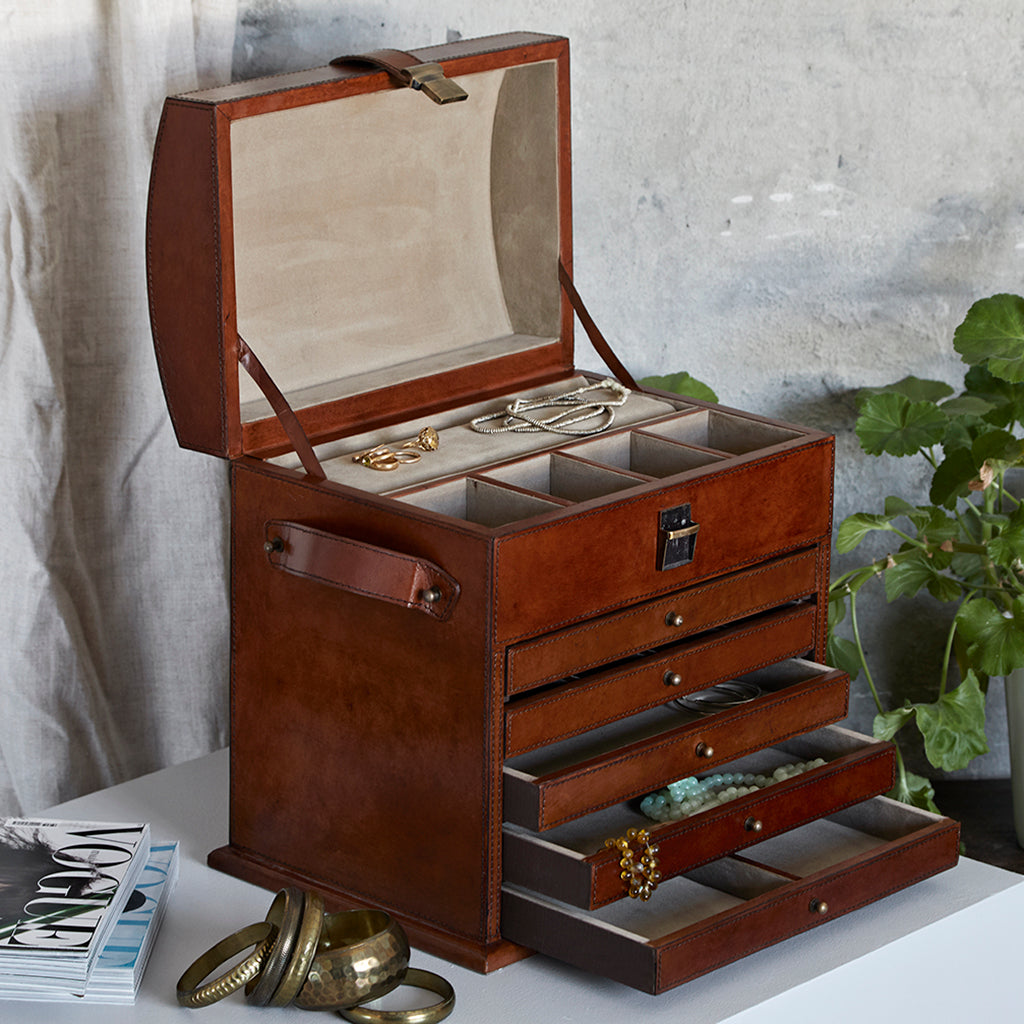 Leather jewellery organiser showing with the lid open and three bottom drawers open the two top draers are closed l
