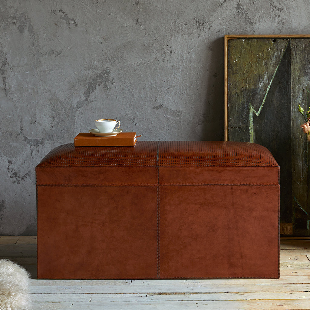 Leather ottoman storage chest closed, storage gtrunk has detailed perforation to the top and generous storage