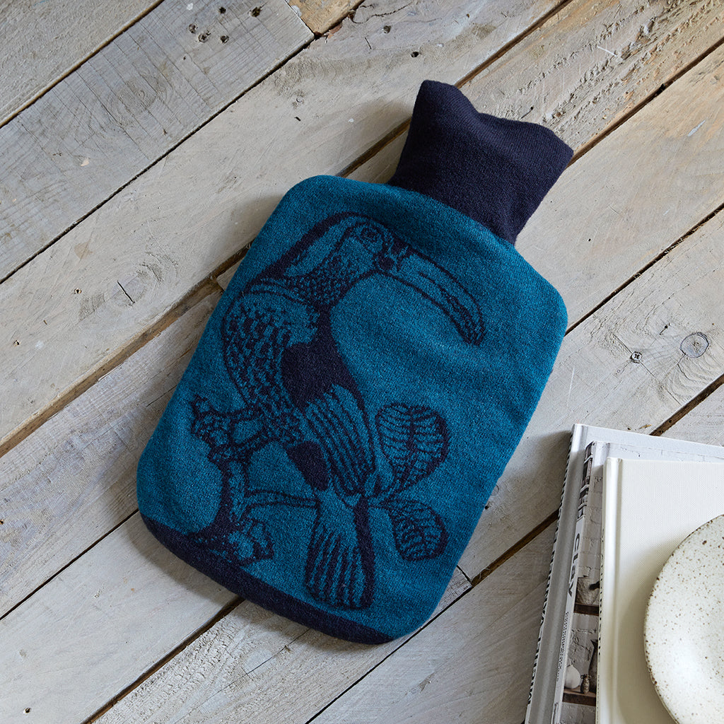 Merino wool toucan hot water bottle cover  in navy and teal, showing bird detail on front of hot water bottle