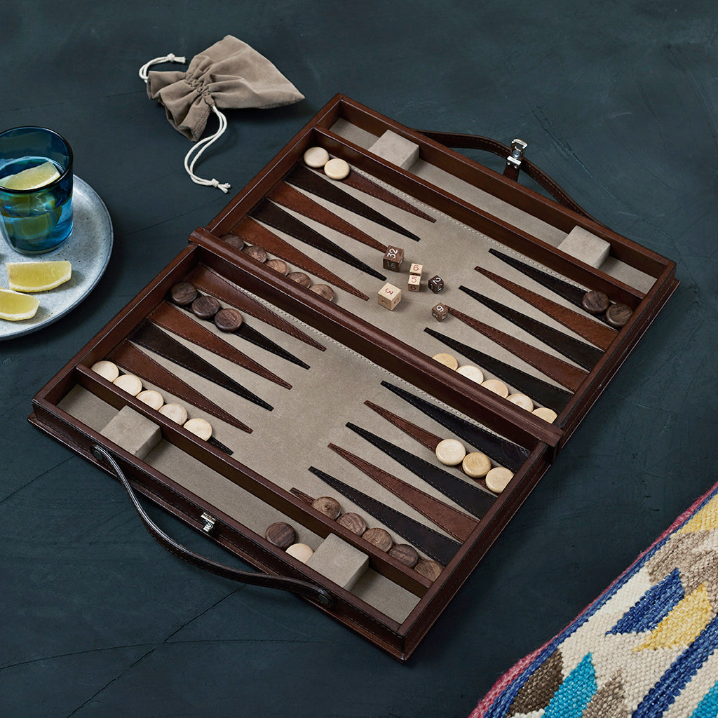 Leather backgammon game open in play with drawstring bag for play pieces shown