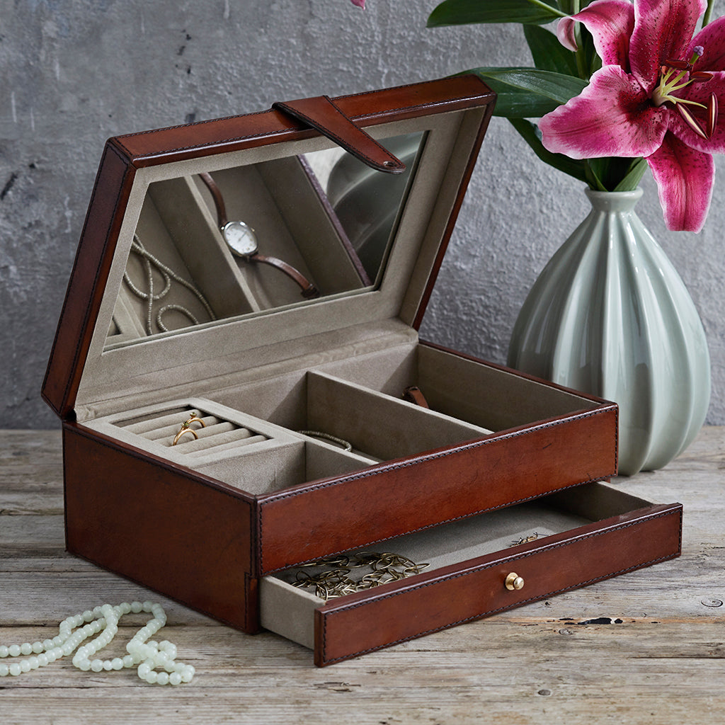Leather jewellery box with the top open to shaow the inside and the mirror.  The single bottom drawer is also partially open.