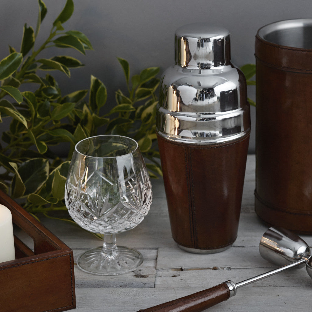 Conker brown leather and nickel cocktail shaker shown with a leather handles spirit measure and leather win cooler