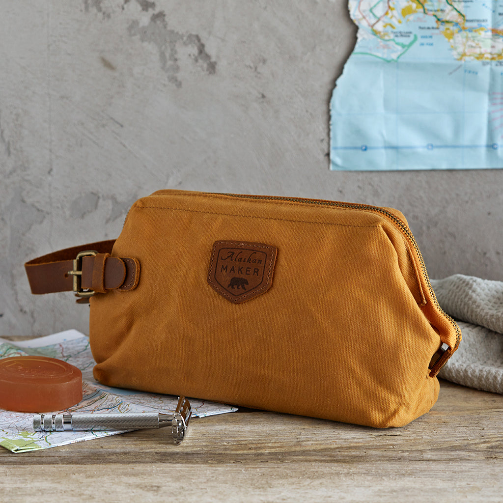 closed waxed canvas toiletry bag in mustard canvas