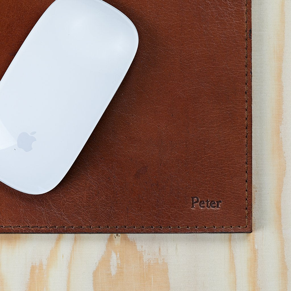 Leather mouse mat to show embossing in right hand corner, this is embossed with the words Peter 