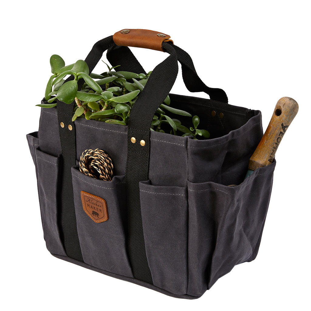 gardening bag filled with string, tools and a plant