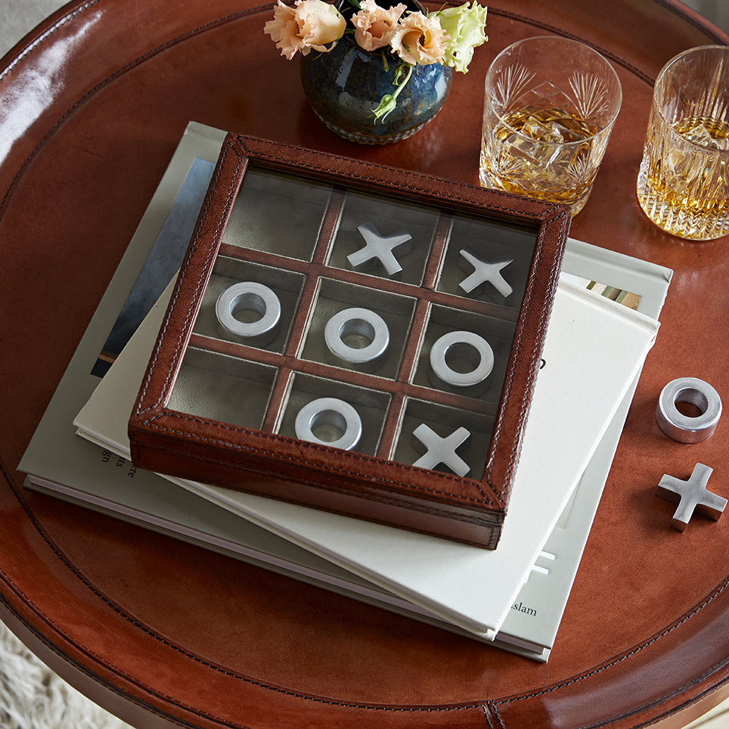 Leather noughts and crosses in leather and faux suede box with removable glass lid