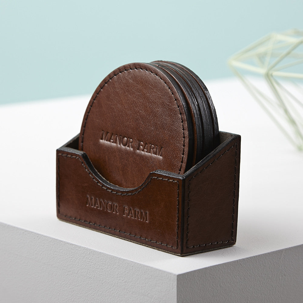 Set of six round leather coasters personalised in a persoanlised leather holder a perfect home warming gift