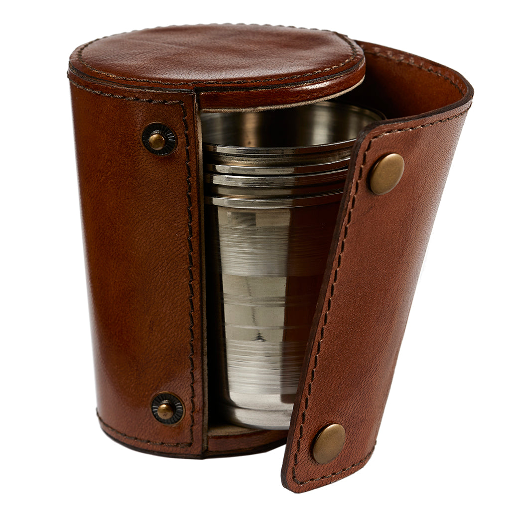 Four metal stirrup cups presented in a leather case with stud popppers to close